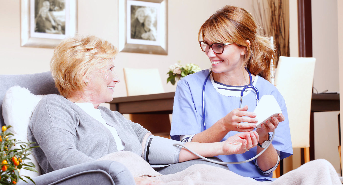 caregiver and senior woman are smiling