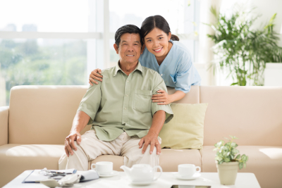 senior man and caregiver are smiling