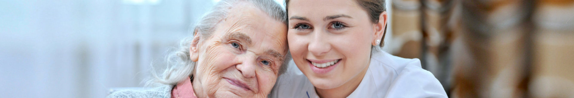 caregiver and senior woman are smiling